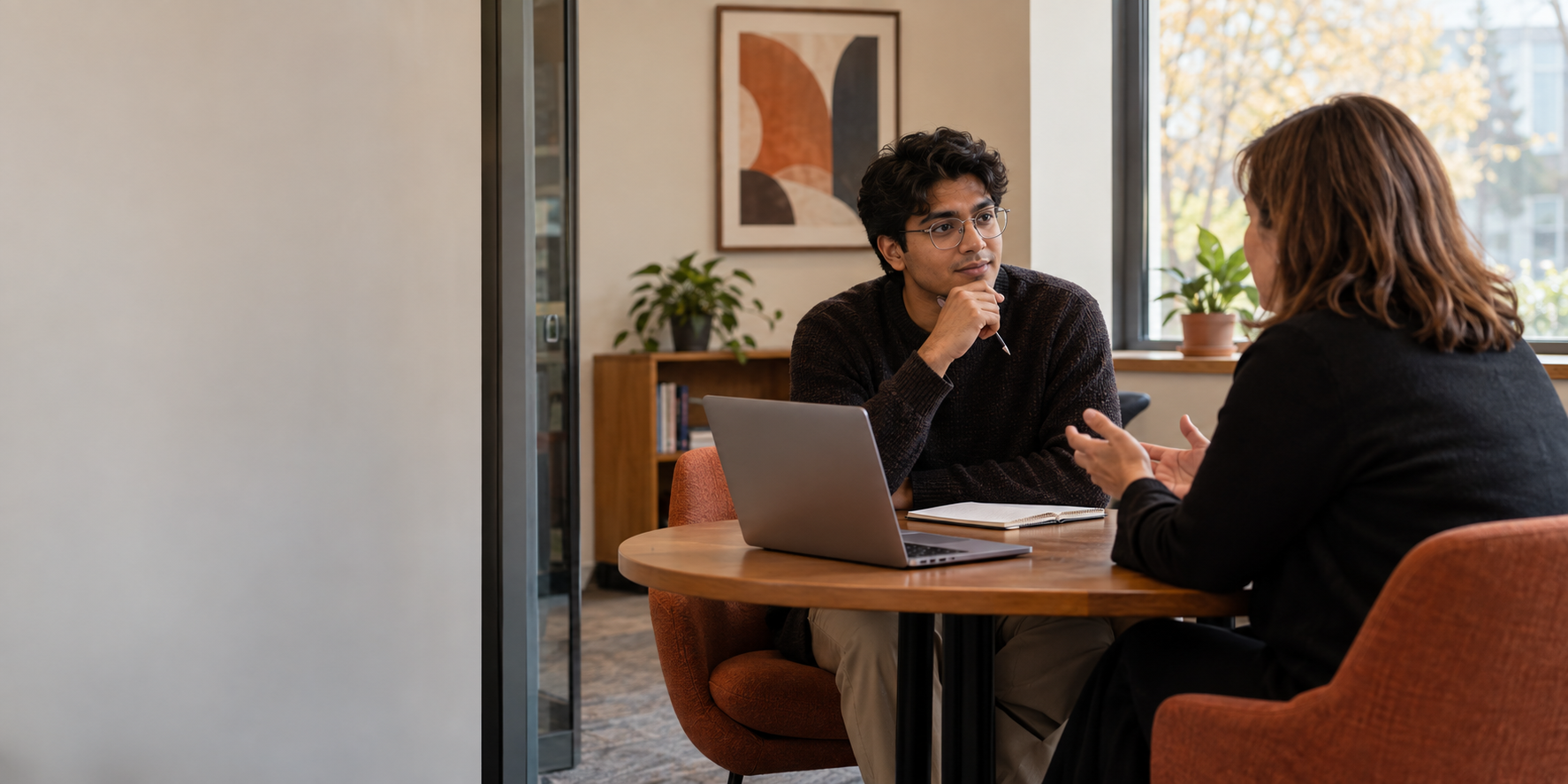 An international graduate and a recruiter having a focused work-authorization conversation.